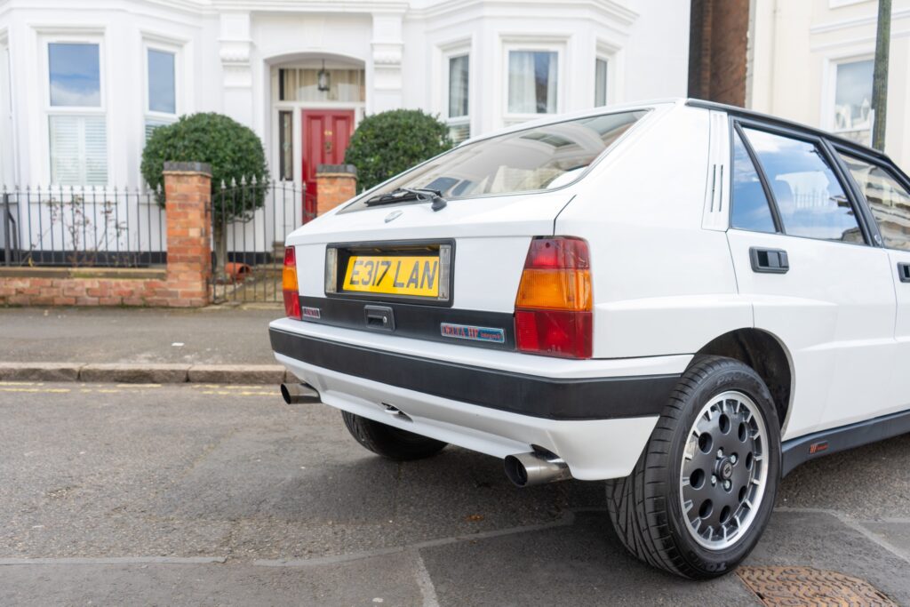 1988 Lancia Delta HF Integrale rear three quarter showcasing twin exit aftermarket exhaust
