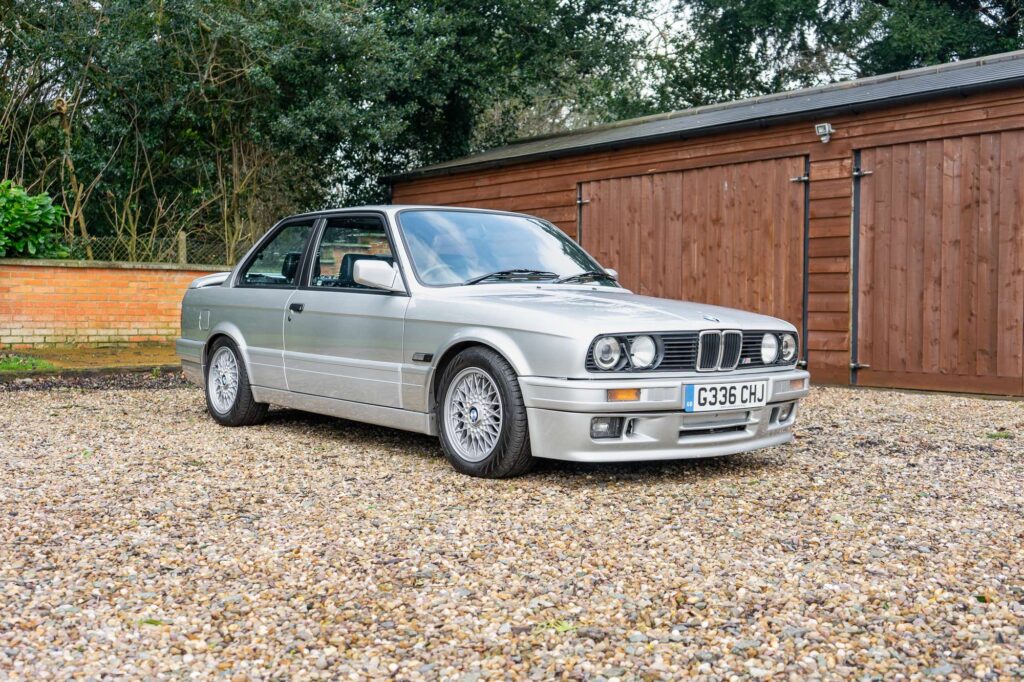 BMW 325i (E30) in Sterling Silver front three quarters shot on a gravel driveway - Classic BMW for sale
