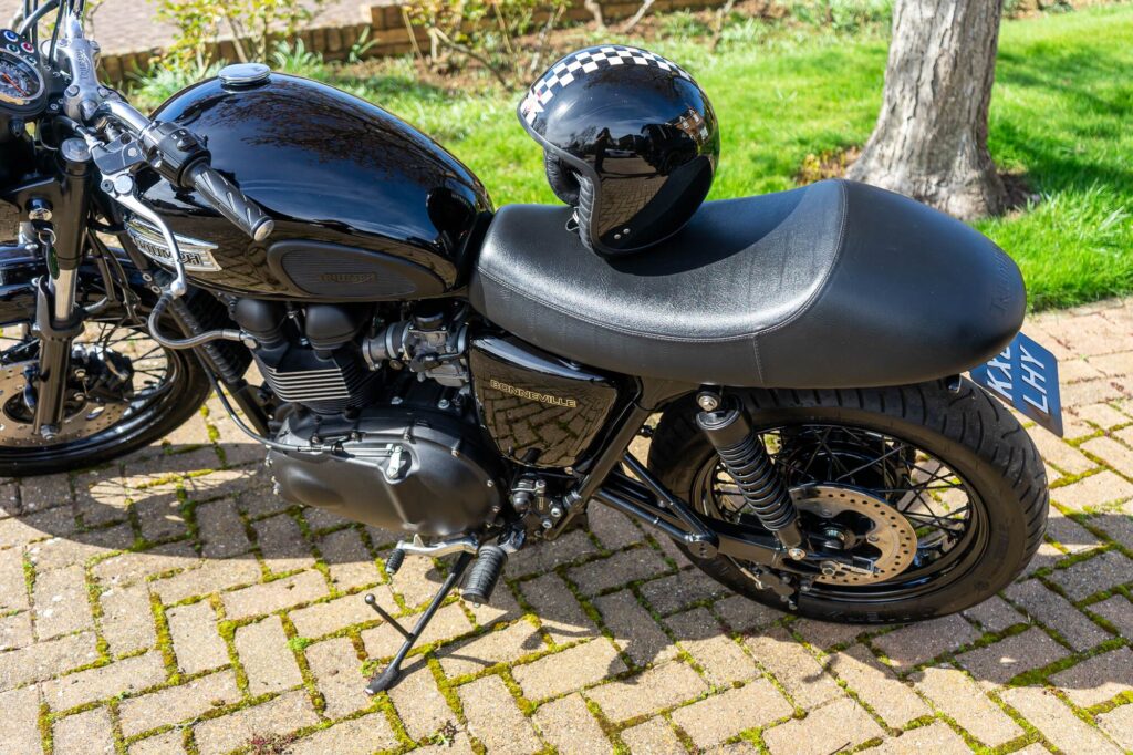 A helmet captured on the seat of a T100 Bonneville which is available as part of the sale.