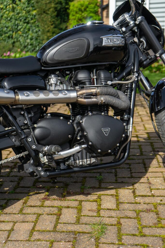 Arrow exhaust with wrapped down pipe fitted to a Triumph Bonneville T100 custom