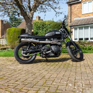 A Triumph Bonneville T100 Custom for sale in Northampton. This bike is captured on the driveway of the owner's house and aims to demonstrate the bike is from a good reliable home.